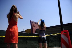Sisters Rachel and Heather Meyer, of Port Washington, Wis., stop on their way to California to photograph the Century Aurora 16 theater complex Tuesday. (AAron Ontiveroz, The Denver Post